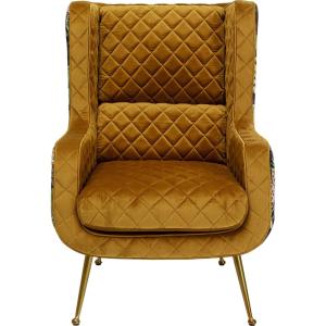 Fauteuil en velours ocre matelassé et imprimés jungle